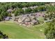 Aerial view of the golf course and country club surrounded by mature trees and lush landscaping at 15431 Cimarron Hills Ln, Charlotte, NC 28278