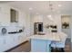 Modern kitchen with stainless steel appliances, white cabinetry, and a center island with seating at 15431 Cimarron Hills Ln, Charlotte, NC 28278