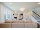 Spacious living room with cozy seating, fireplace, and stairs to the upper level at 15431 Cimarron Hills Ln, Charlotte, NC 28278