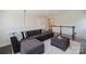 Comfortable living room with dark gray sectional seating and staircase in background at 15431 Cimarron Hills Ln, Charlotte, NC 28278