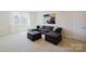 Inviting living area featuring a comfortable sectional sofa, plush carpeting, and lots of space at 15431 Cimarron Hills Ln, Charlotte, NC 28278