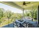 Relax on the covered outdoor living area with comfortable seating and a tranquil view at 15431 Cimarron Hills Ln, Charlotte, NC 28278