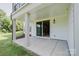 Covered patio featuring a smooth concrete flooring and sliding glass door access to the home at 15431 Cimarron Hills Ln, Charlotte, NC 28278