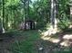 Shed with open door set amongst trees at 163 Shanna Ln, Statesville, NC 28625