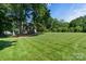 Expansive backyard features lush green lawn and mature trees at 1721 White Pond Ln, Waxhaw, NC 28173