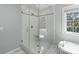 Bathroom featuring walk-in shower, soaking tub and large window with natural light at 1721 White Pond Ln, Waxhaw, NC 28173