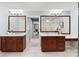 Dual vanities, cherry cabinets, and open access to an adjacent shower at 1721 White Pond Ln, Waxhaw, NC 28173