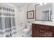 Neutral bathroom with a shower/tub combo, a vanity, and white tile flooring at 1721 White Pond Ln, Waxhaw, NC 28173