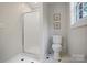 Clean bathroom with shower, toilet, tiled floors and a bright window at 1721 White Pond Ln, Waxhaw, NC 28173