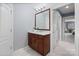 Bathroom featuring a wood vanity with marble countertop and updated mirror with lighting at 1721 White Pond Ln, Waxhaw, NC 28173