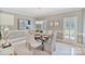 Elegant dining room with crown molding, modern lighting fixture and large window with plantation shutters at 1721 White Pond Ln, Waxhaw, NC 28173