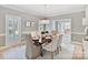 Elegant dining room with a stylish chandelier, setting for six, and large windows at 1721 White Pond Ln, Waxhaw, NC 28173