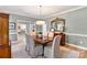 Dining room with neutral colors, chandelier, and natural light shining on hardwood floors at 1721 White Pond Ln, Waxhaw, NC 28173