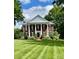 Stately brick home with white columns and manicured lawn creates a grand and inviting curb appeal at 1721 White Pond Ln, Waxhaw, NC 28173