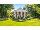 Beautiful two-story brick home with a lush green lawn and stately mature trees at 1721 White Pond Ln, Waxhaw, NC 28173
