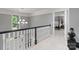 Upstairs hallway with black and white railing and a view into the main bedroom at 1721 White Pond Ln, Waxhaw, NC 28173