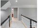 Hallway with modern decor and view into bathroom with wood cabinets and shower at 1721 White Pond Ln, Waxhaw, NC 28173