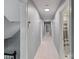 Long hallway with neutral walls, carpet and recessed lighting; several doors on each side at 1721 White Pond Ln, Waxhaw, NC 28173
