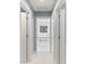 Bright hallway leading to Primary bath with soaking tub and large window at 1721 White Pond Ln, Waxhaw, NC 28173