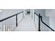 Upstairs hallway showcasing black banister, fresh neutral paint, and plush carpeting at 1721 White Pond Ln, Waxhaw, NC 28173