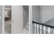 Hallway with stairs leading up, neutral paint and a glimpse into a bedroom at 1721 White Pond Ln, Waxhaw, NC 28173