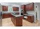 Beautiful kitchen with stainless steel appliances, wooden cabinets, and center island cooktop at 1721 White Pond Ln, Waxhaw, NC 28173
