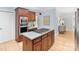 Kitchen features stainless appliances, custom wood cabinets, and a functional center island with gas cooktop at 1721 White Pond Ln, Waxhaw, NC 28173
