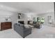 Cozy living room featuring a brick fireplace, hardwood floors, and access to the outdoor space at 1721 White Pond Ln, Waxhaw, NC 28173
