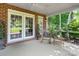 Inviting brick patio with rocking chair, table, and lush backyard views at 1721 White Pond Ln, Waxhaw, NC 28173