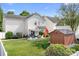 Well-maintained backyard featuring a patio, shed, and green grass at 18027 Train Station Dr, Cornelius, NC 28031