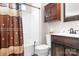 Bathroom featuring a shower-tub, vanity with wooden cabinets, decorative mirror, and soft lighting at 18027 Train Station Dr, Cornelius, NC 28031