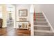 Inviting entryway with staircase, table, and hardwood flooring at 18027 Train Station Dr, Cornelius, NC 28031