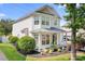 Charming two-story home featuring manicured landscaping and a welcoming front porch at 18027 Train Station Dr, Cornelius, NC 28031
