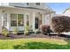 Charming front porch adorned with flowers and greenery offers a warm welcome to this lovely home at 18027 Train Station Dr, Cornelius, NC 28031