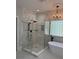 Elegant bathroom featuring a glass-enclosed shower and freestanding tub at 19409 Laurel Glen Ave, Cornelius, NC 28031