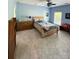 Well-lit bedroom with wood furniture, ceiling fan, and warm decor at 19409 Laurel Glen Ave, Cornelius, NC 28031