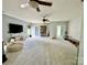 Spacious bonus room with neutral walls and carpet, ceiling fans, and natural light at 19409 Laurel Glen Ave, Cornelius, NC 28031