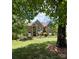 Beautiful brick home with manicured lawn and blue shutters and door at 19409 Laurel Glen Ave, Cornelius, NC 28031