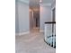 Upstairs hallway with neutral walls and carpet leads to private bedrooms at 19409 Laurel Glen Ave, Cornelius, NC 28031