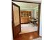 Home office featuring hardwood floors, a wooden desk, and a custom glass-door cabinet at 19409 Laurel Glen Ave, Cornelius, NC 28031