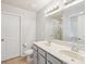 Bright bathroom features a double sink vanity, large mirror, toilet, and bright lighting for an open feel at 217 Almora Loop, Mooresville, NC 28115