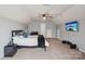 Carpeted bedroom featuring a ceiling fan, TV, and furniture at 217 Almora Loop, Mooresville, NC 28115