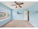 This bedroom features blue walls, carpeted floors, a ceiling fan, and a TV at 217 Almora Loop, Mooresville, NC 28115