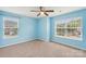 This bedroom features blue walls, carpeted floors and a ceiling fan at 217 Almora Loop, Mooresville, NC 28115
