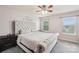 Comfortable bedroom featuring a plush bed, soft carpet, and bright windows, perfect for relaxation at 217 Almora Loop, Mooresville, NC 28115