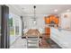 Charming dining area with wood table, modern light fixture, and outdoor view at 217 Almora Loop, Mooresville, NC 28115
