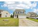 Charming two-story home with a two-car garage, landscaping, and front lawn at 217 Almora Loop, Mooresville, NC 28115