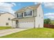 Charming two-story home with a two-car garage and well-maintained lawn at 217 Almora Loop, Mooresville, NC 28115