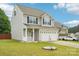 Charming two-story home with a two-car garage, manicured lawn, and landscaping at 217 Almora Loop, Mooresville, NC 28115