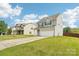 Charming two-story home featuring a two-car garage, driveway, and landscaping at 217 Almora Loop, Mooresville, NC 28115